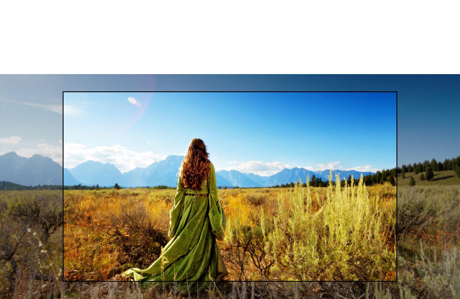 شاشة لتلفزيون يعرض أحد المشاهد من فيلم خيالي تظهر فيه امرأة تقف في الحقول المواجهة للجبال.