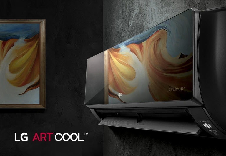 An LG air conditioner with the ARTCOOL mirrored glass exterior is seen hanging on a wall at an angle. The surface is reflecting a painting hanging on the wall next to it. The LG ARTCOOL logo can be seen in the corner of the image.