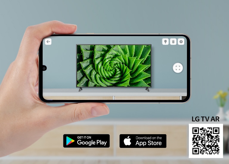 A person using LG TV AR app on a phone and a QR code which links to LG TV AR (http://www.lgtvism.com/lgtvar)