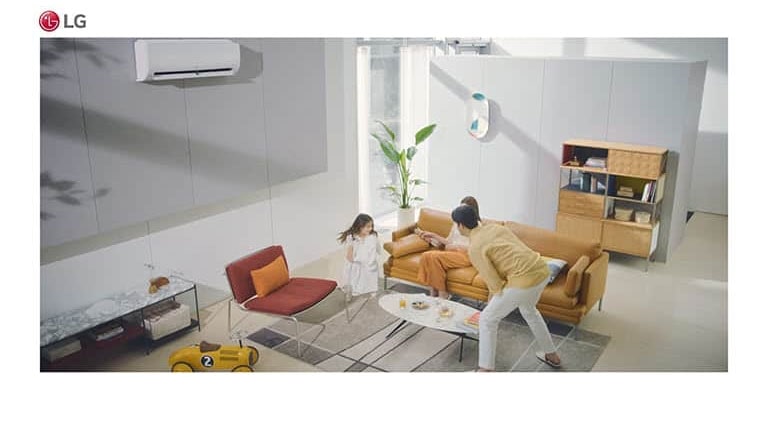 A family plays in a living room and the air condition sits in the top of the picture.