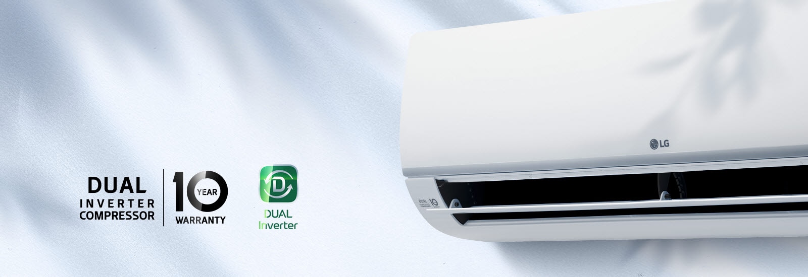 A close up of the front of the air conditioner that features the LG logo in the center and the 10 year warranty logo on the left side. A larger Dual Inverter Compressor | 10 Year Warranty logo, and Dual Converter logo are to the left of the image shine as a light glows across them.
