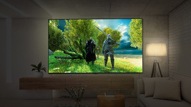 A large-screen TV mounted on a wall in a dark room. The scene shows a rear view of two characters wearing armor.