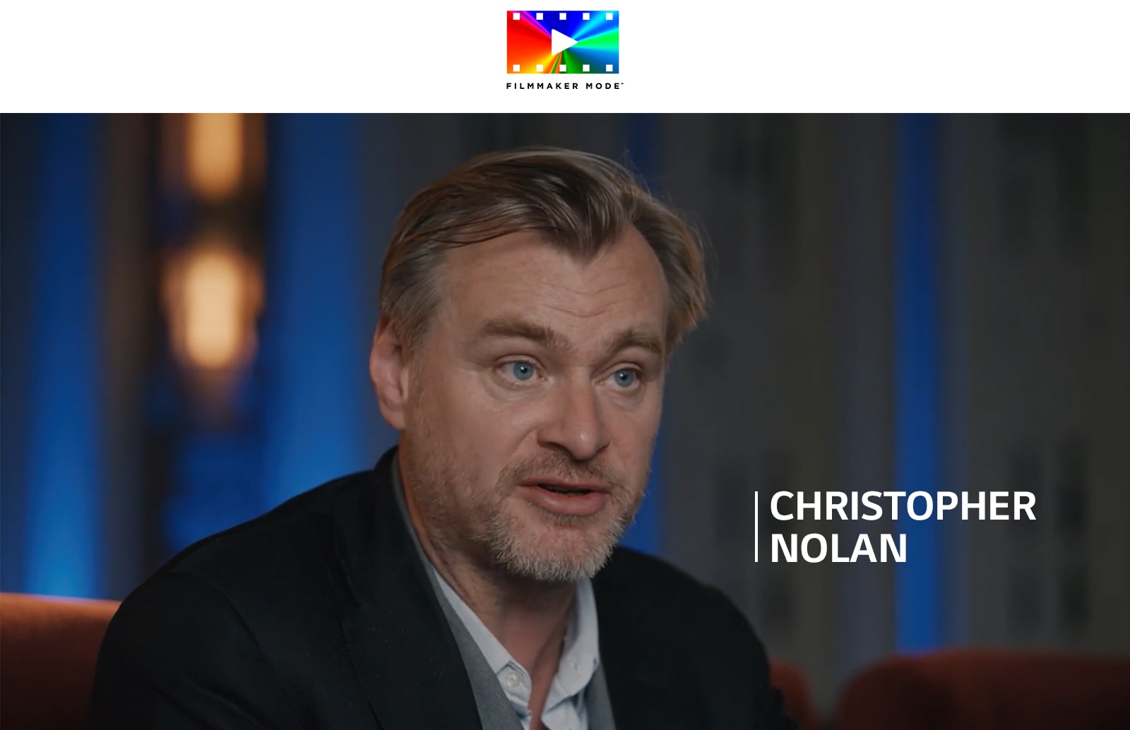 Christopher Nolan doing an interview in a theatre room.