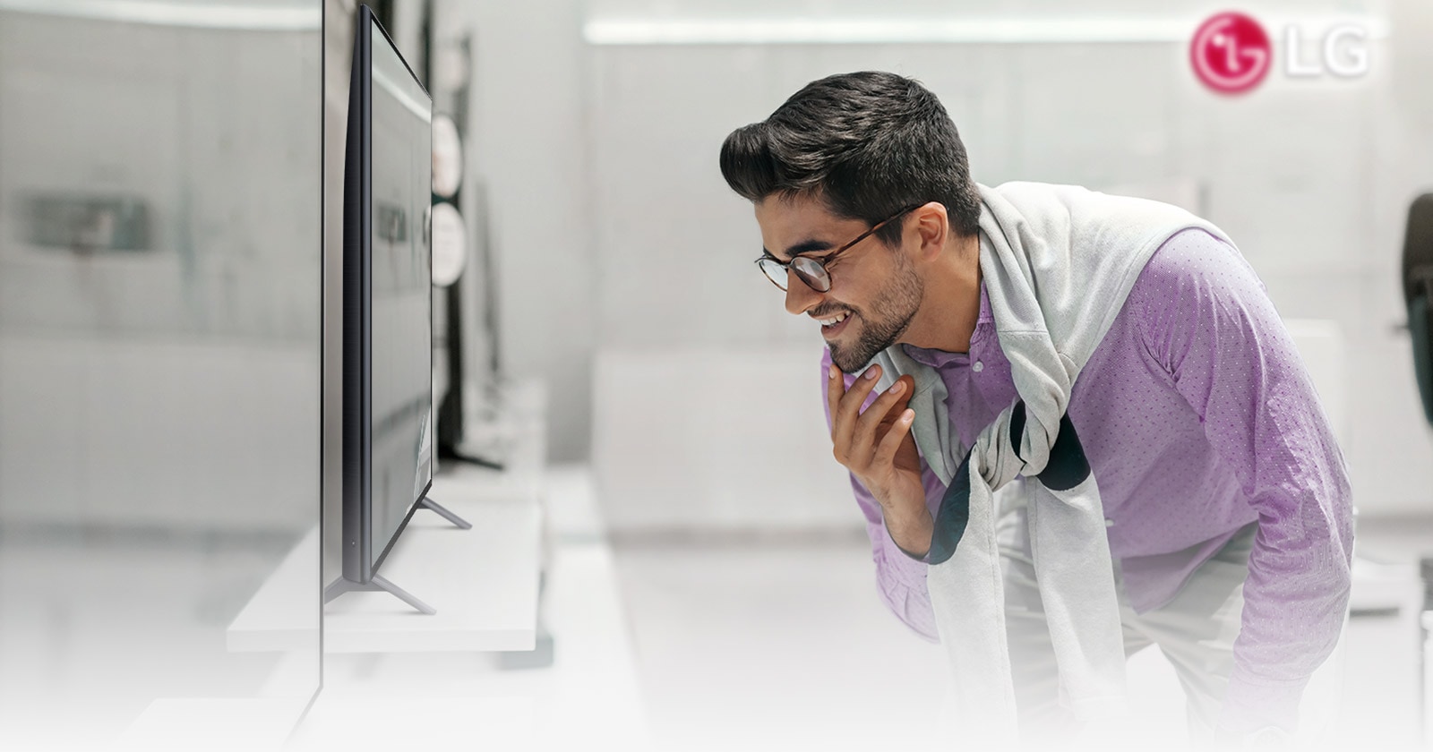 A man bending down to examine a product.