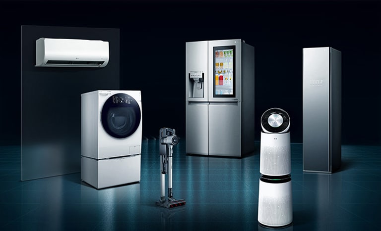 An air purifier, refrigerator, styler, washing machine, and vacuum arranged in a dark setting.